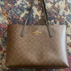 Like new brown monogram Coach tote bag.